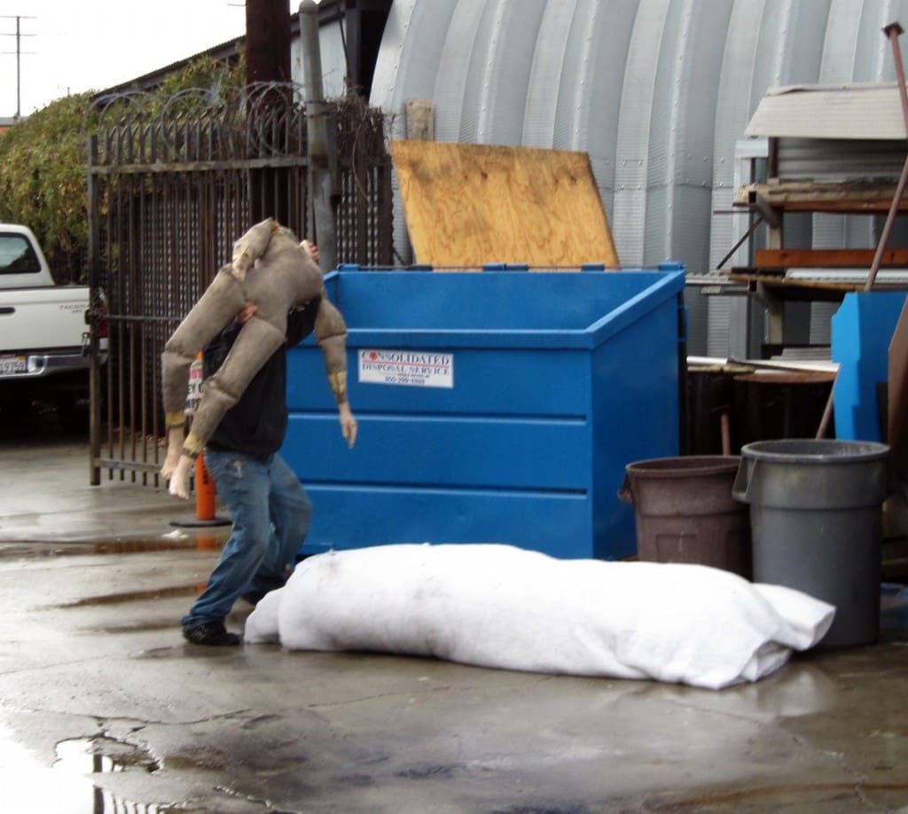 Ignominious end decapitated dummy heaved into dumpster