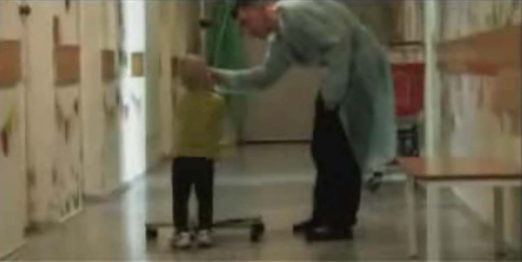tiny child pulling adult-size IV around