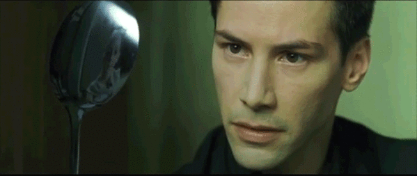 Keanu Reeves stares at a bendy spoon in a scene from The Matrix